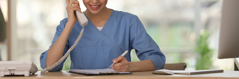 receptionist at desk answering phone